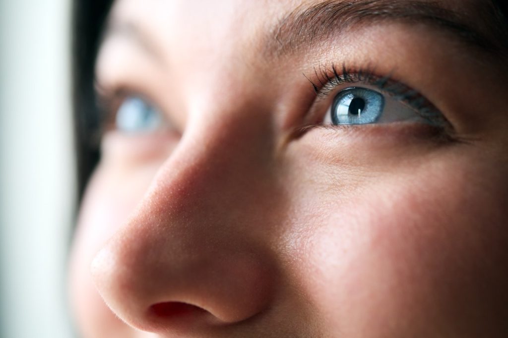close up of a womens blue eyes